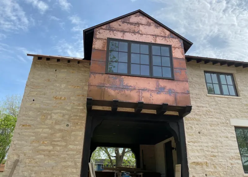 Copper metal panel facade on a stone building for Roof Repair in Ossining